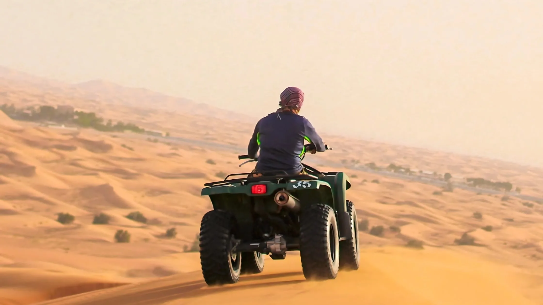 enjoying the Abu Dhabi desert safari with quad bike