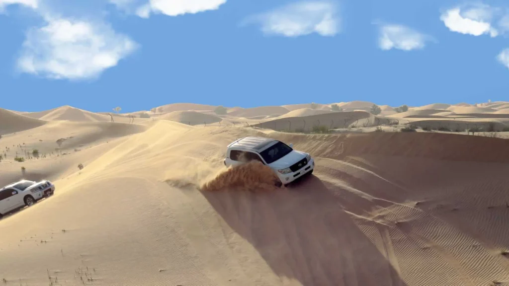 SUV dune bashing on tall sand dunes in Liwa Desert Abu Dhabi, part of the Empty Quarter.