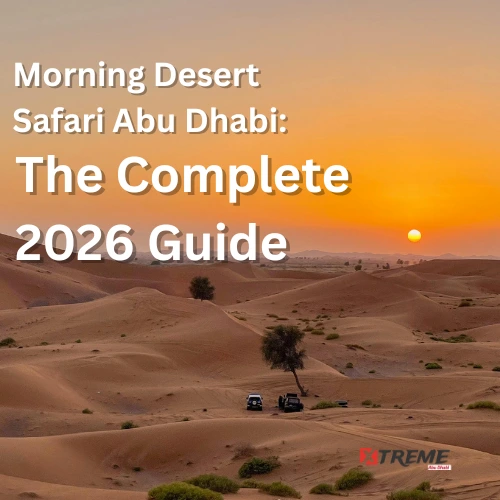 Two 4x4 vehicles crossing the golden sand dunes of Al Khatim Desert at sunrise during a morning desert safari in Abu Dhabi, with a warm amber sky and the sun low on the horizon.