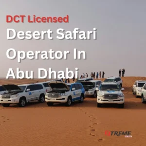 Fleet of licensed Toyota Land Cruiser 4x4 vehicles parked on Abu Dhabi desert dunes with guests exploring the sandscape