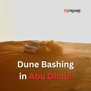 Desert safari dune bashing in Abu Dhabi — Toyota Land Cruiser on red sand dunes at Al Khatim